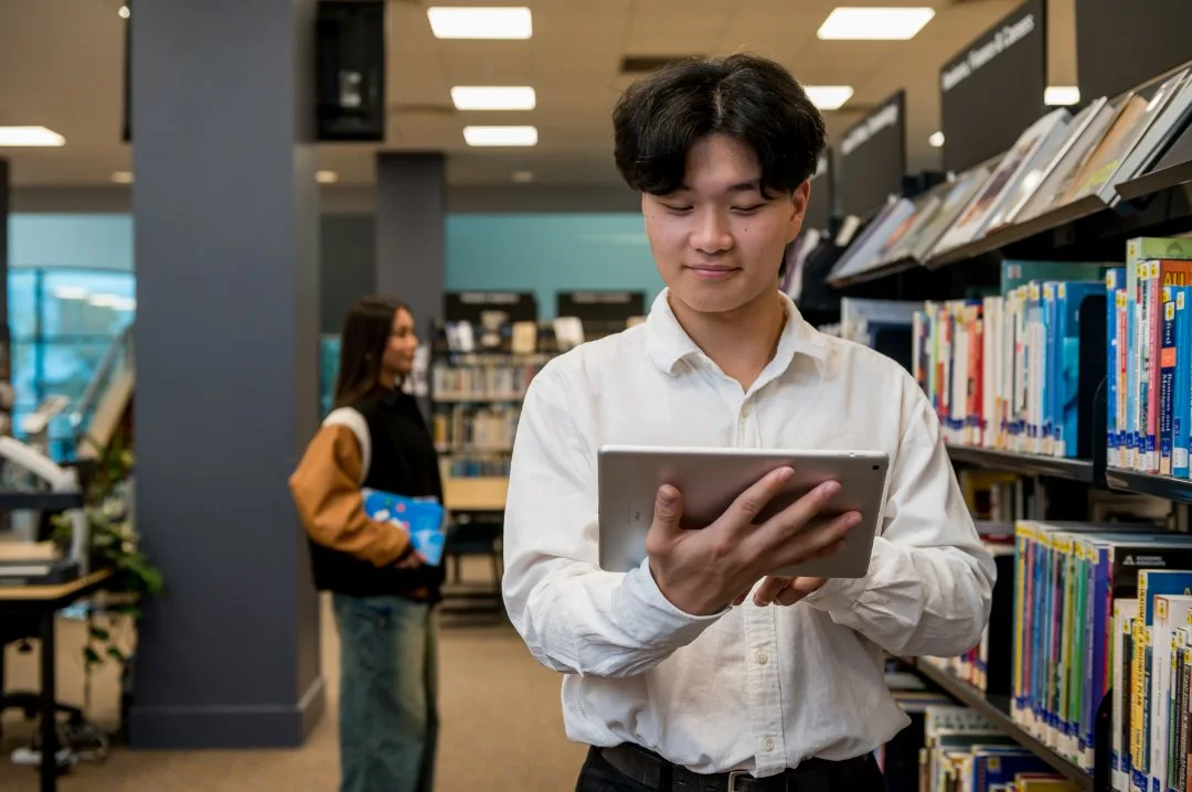 Photo of a person studying at a library